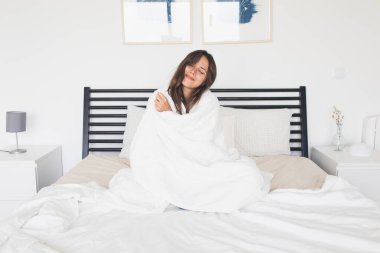 Woman in Bed Feeling Cozy and Warm