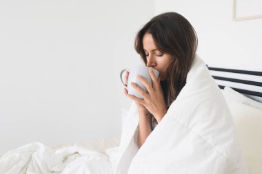 Woman Drinking Coffee in Bed Cozy and Comfortable