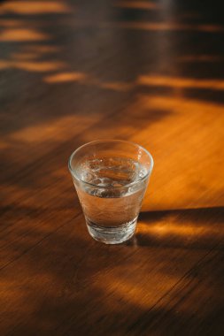 Glass of Iced drinking water on rustic wooden table