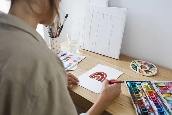 Woman Painting with Watercolor on Desk with Art Materials Creativity