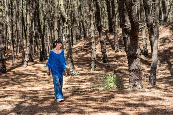 Woman walking in the woods.