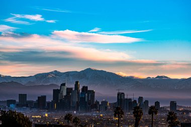 Snow Capped Mountains Sit Behind Los Angeles Skyline