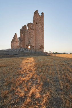 Caudilla castle in ruins in a field with sun rays at sunset in spring.Toledo, Castilla La Mancha, Spain
