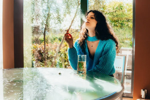 lonely woman drinking and smoking at home