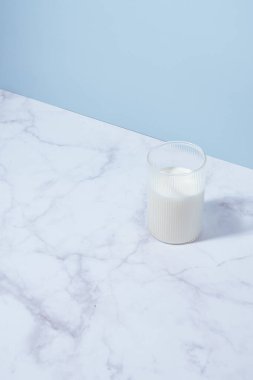 milk in a glass on a marble table