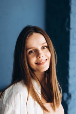 young blonde with braces is smiling