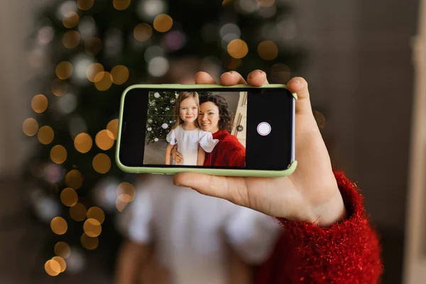 mom and daughter make a New Year\'s selfie on the phone