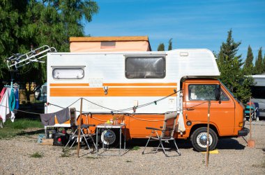 Cartagena, Spain : 2022 November 23 : Old VW Motorhome camping on a sunny day in autumn 2022. clipart