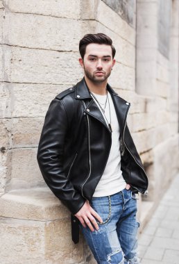 Young happy smiling bearded man brunette outdoors