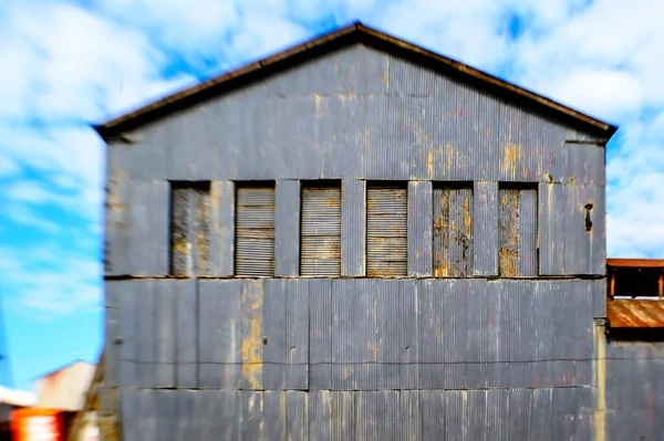 Exterior of an old storage building with metal siding.