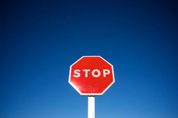 Stop traffic sign with cloudless sky.