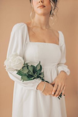 Close Up of Woman Elegantly Holding White Roses