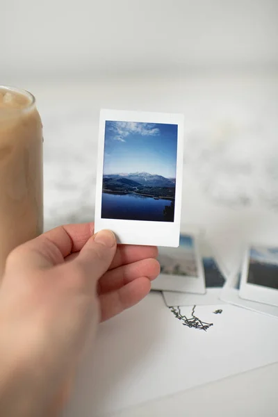 Hand Holding Polaroid Photo Mountain World Map Iced Coffee — Zdjęcie stockowe