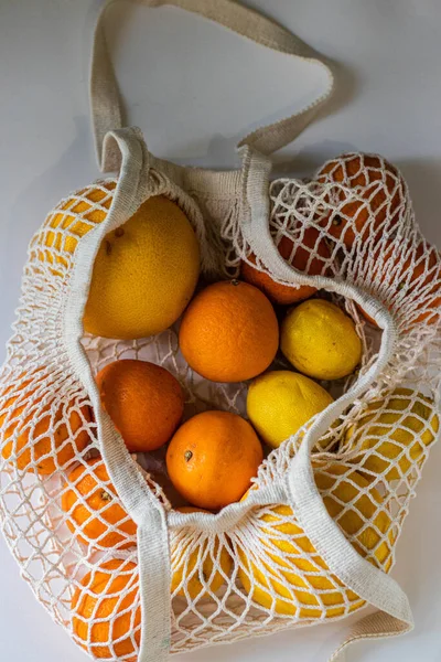 citrus fruits in a string bag