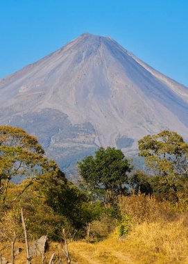 Colima volcano on a clear day with blue skies