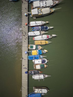 Beautiful view to tour boats on ocean pier in small historic town