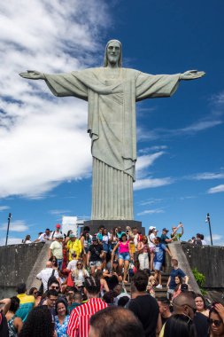 Beautiful view to tourists on Christ the Redeemer statue with blue sky and sunny day, Rio de Janeiro, Brazil