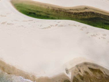 Beautiful aerial view to white sand dunes and green rainwater pools in Lenis Maranhenses, near Barreirinhas, Maranho, Brazil 