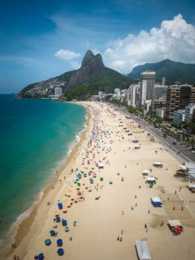 Beautiful aerial view to beach, ocean, city buildings and mountains in sunny summer day, Rio de Janeiro, Brazil