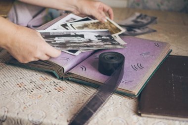 Woman looking at retro photos in vintage album, old photo film clipart