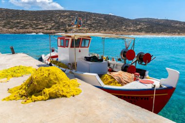 Colorful boat in blue water on Amorgos, Greek Islands