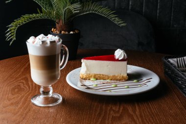 cheesecake and coffee on a wooden table in a coffee shop