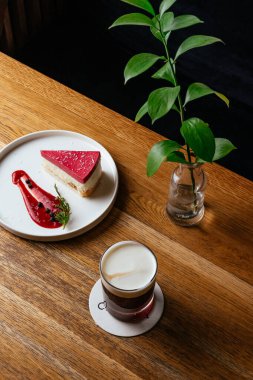 cheesecake and coffee on a wooden table in a coffee shop