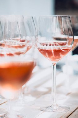 several defocused rose wine glasses