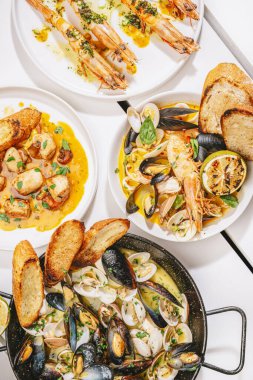 four different seafood dishes in the table