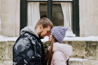 couple in love is walking through a snowy winter town
