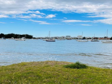 Boats floating in blue river water on clear summer day