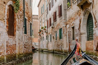 View of colorful buildings overlooking the canal while in a gondola