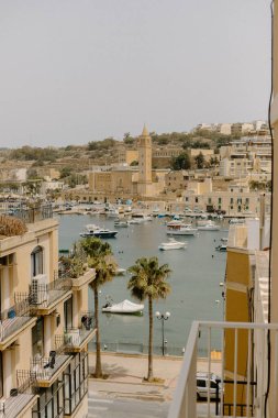 Warm view of a port in a fishing village in Malta clipart