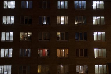 Geceleri evdeki pencereler. Apartman pencerelerinden gelen ışık.