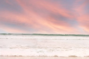 Pink sunset over the ocean waves