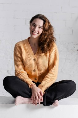 portrait of a beautiful smiling young woman sitting on the floor