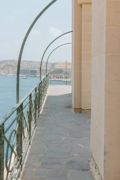 Walkway along a balcony looking over the Mediterranean Sea in Malta