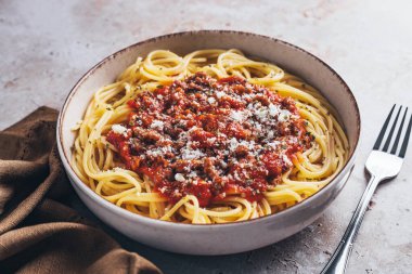 High angle view of spaghetti with bolognese sauce on stone background.