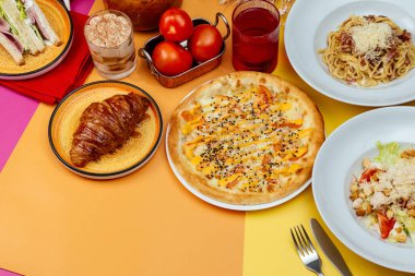 Italian pasta, pizza and caesar salad on bright backgrounds. moc