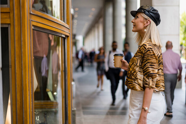 Fashionable woman looking at a shop window