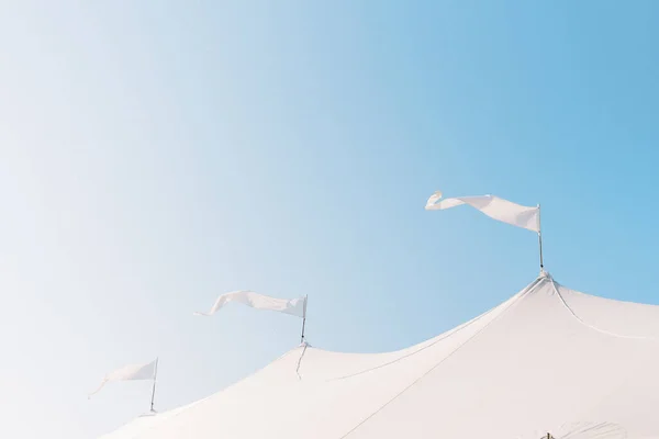 Three White Flags Flying Breeze Top Tent Sunny Day — Stok fotoğraf
