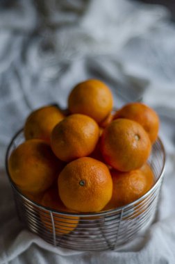 metal basket with tangerines close-up