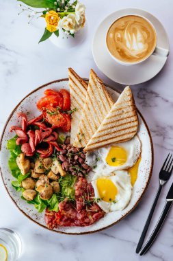 english breakfast with scrambled eggs, bacon, beans, mushrooms a