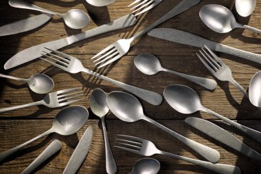 Metal cutlery on a wooden table
