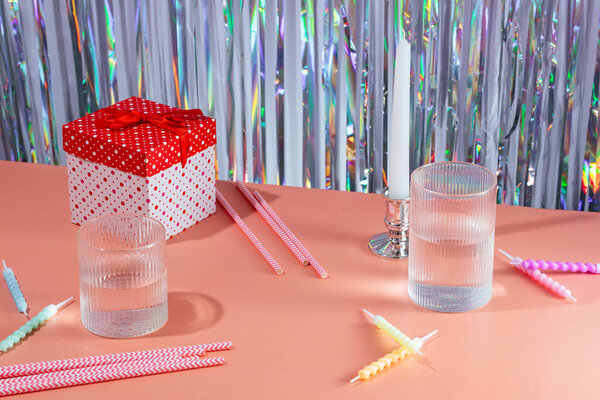 festive atmosphere, gift box, cake candles, cocktail tubes, bright background