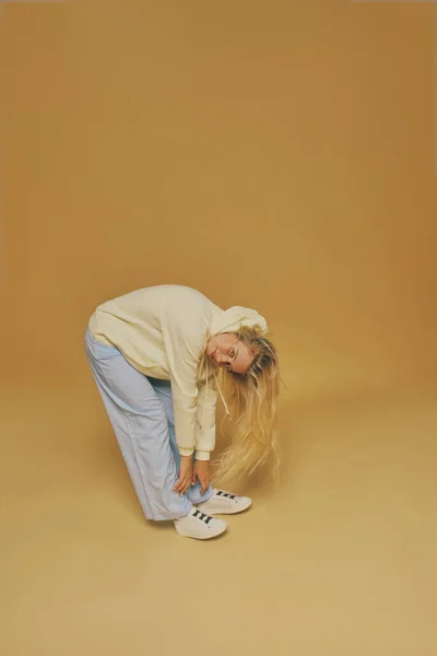 stock image Young freckles woman wearing a yellow sweatshirt