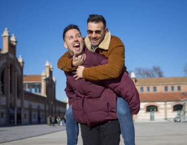A portrait of happy gay couple outdoors