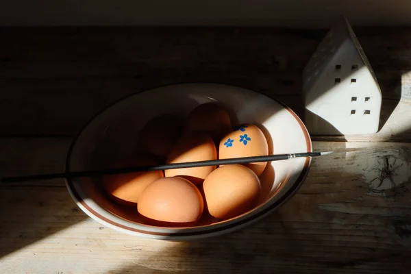 Chicken eggs in a plate, painted egg, Easter