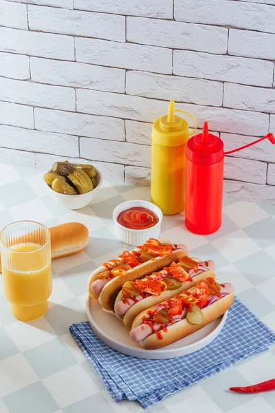 american hot dogs in a plate on a light table