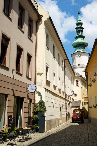 stock image Bratislava, Slovakia - June 24, 2019: A tourist car runs through the old town of Bratislava, in the background you can see Saint Michael Gate tower.